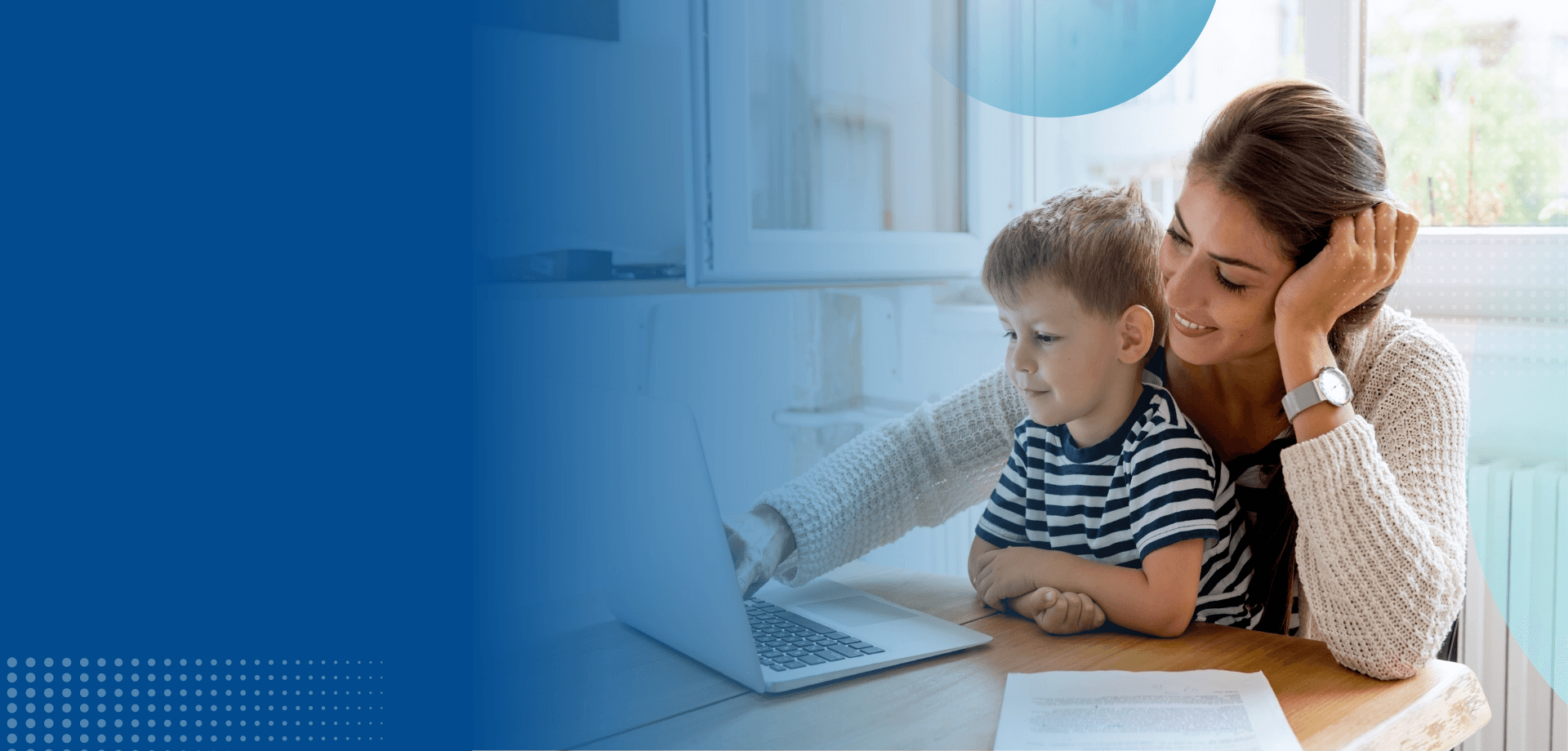 Mother and child reviewing documents on a laptop