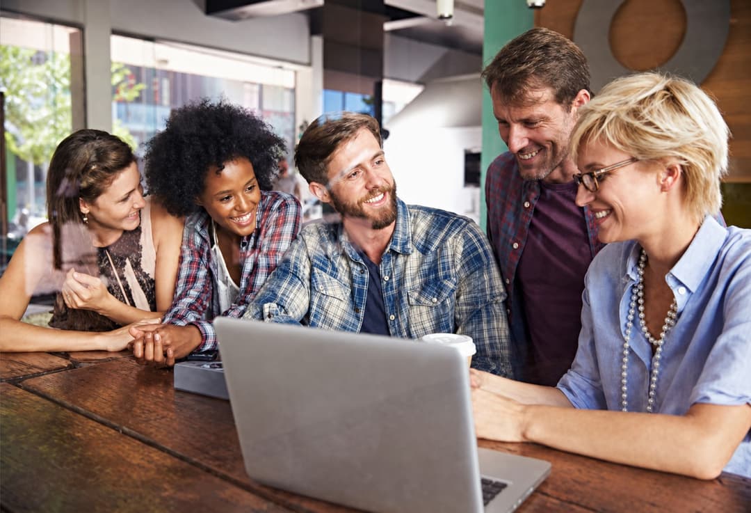 Group reviewing tax filing documents on a laptop